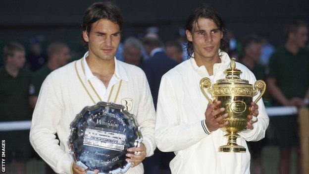 Rafael Nadal holds Wimbledon trophy as Roger Federer holds runners-up trophy