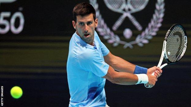 Novak Djokovic hits a backhand