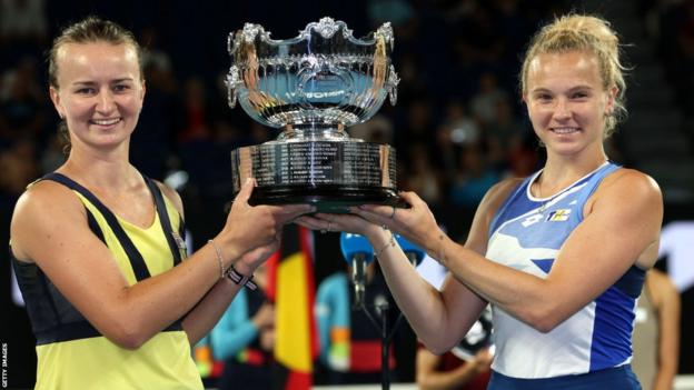 Barbora Krejcikova and Katerina Siniakova hold aloft the Australian Open women's doubles trophy