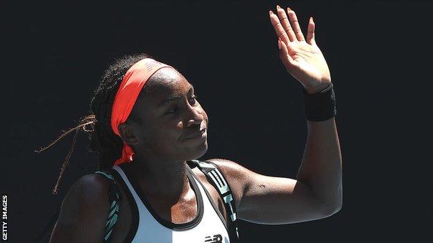 Coco Gauff waves goodbye to the Melbourne crowd after losing to Jelena Ostapenko