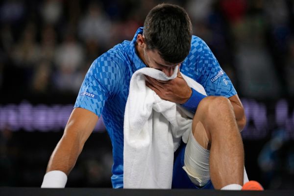 Novak Djokovic overcomes injury, heckler to advance in Melbourne