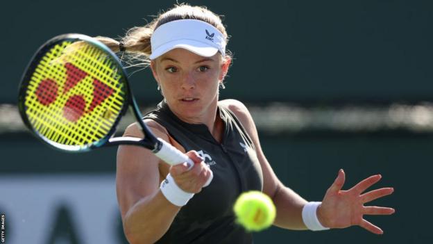 Katie Swan hits a return in her Indian Wells first-round match against Cristina Bucsa