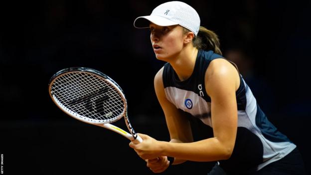 Iga Swiatek in action against Zheng Qinwen at the Porsche Tennis Grand Prix