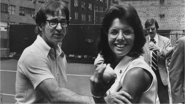 Bobby Riggs checks Billie Jean King's muscles.