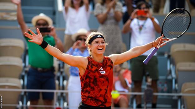 Karolina Muchova with her arms outstretched in celebration