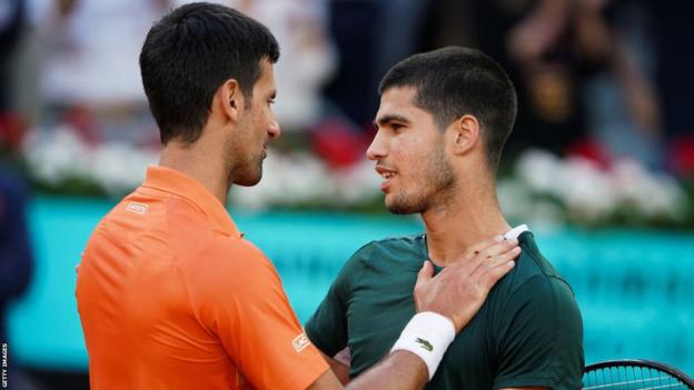 Novak Djokovic and Carlos Alcaraz embrace after their Madrid Open match in 2022