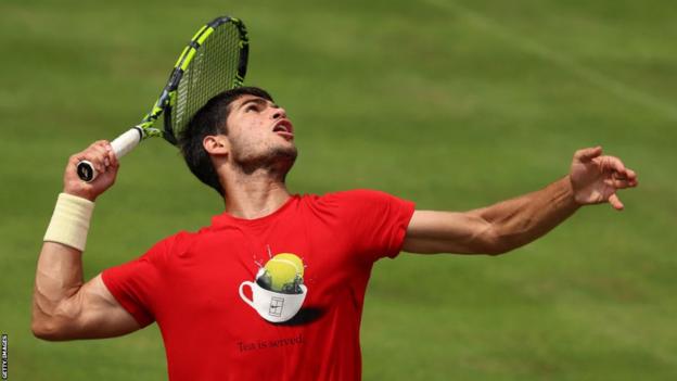 Carlos Alcaraz serves during a practice session at Queen's Club