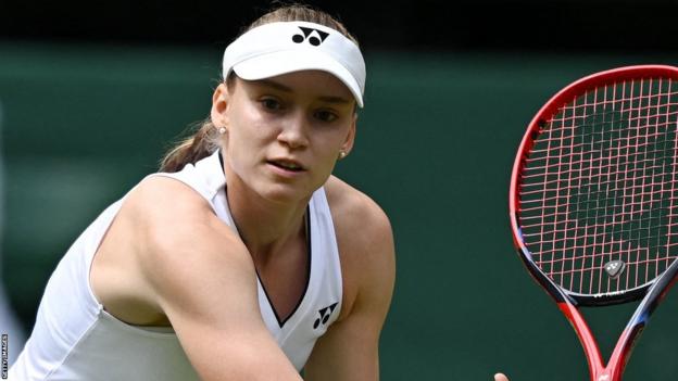 Elena Rybakina volleys at the net