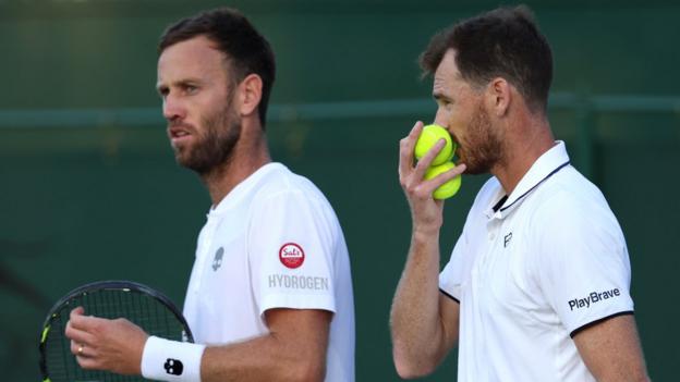 Jamie Murray and Michael Venus confer before a point