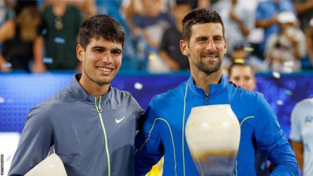 Carlos Alcaraz and Novak Djokovic pose with their trophies after the Cincinnati final