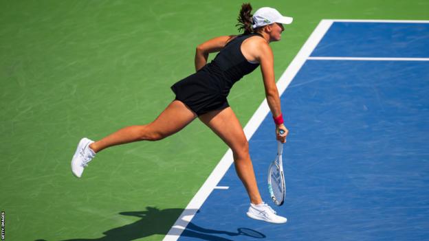 Iga Swiatek returns the ball on court at the Cincinnati Open