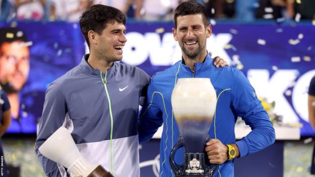 Carlos Alcaraz of Spain and Novak Djokovic of Serbia pose with their trophies after the final of the Western & Southern Open