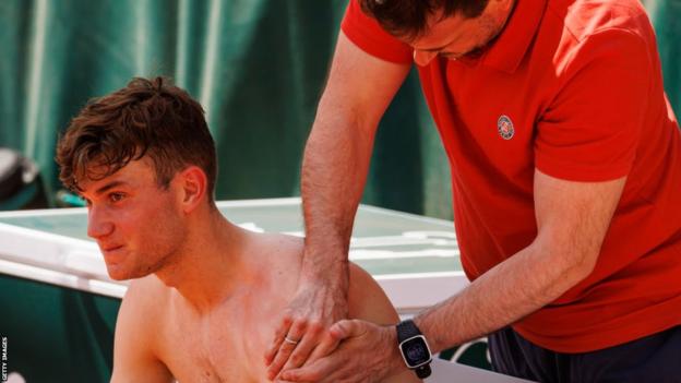 Jack Draper has treatment on a shoulder injury at the French Open