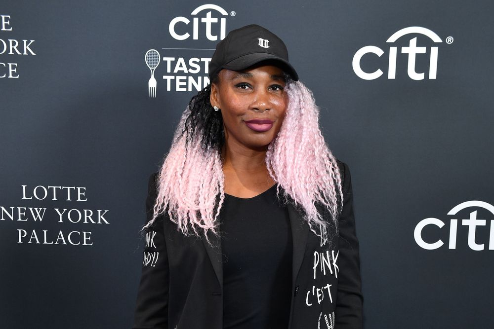 A pink-haired Venus Williams arrived wearing a cap from her own Eleven collection.