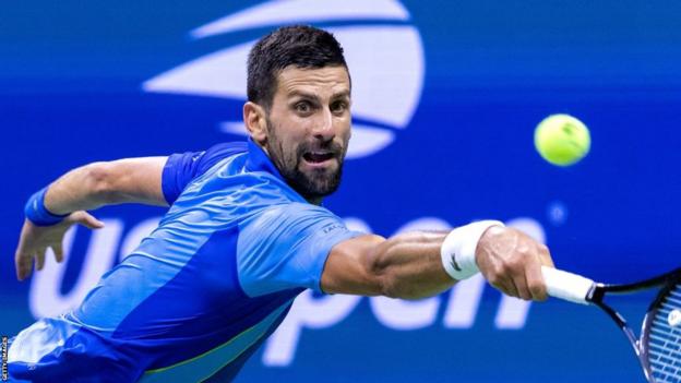 Novak Djokovic stretches for a backhand at the US Open