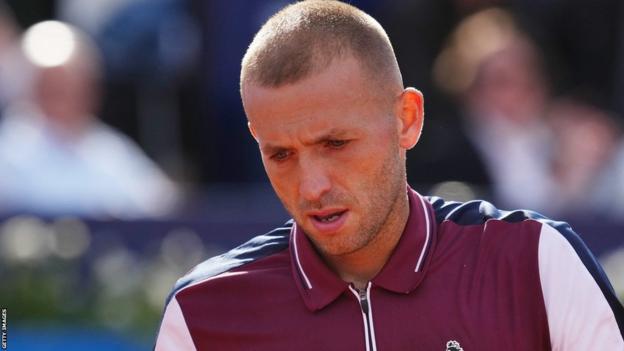 Dan Evans looking down after his defeat by Carlos Alcaraz