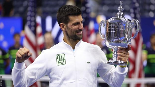 Novak Djokovic lifts the US Open trophy