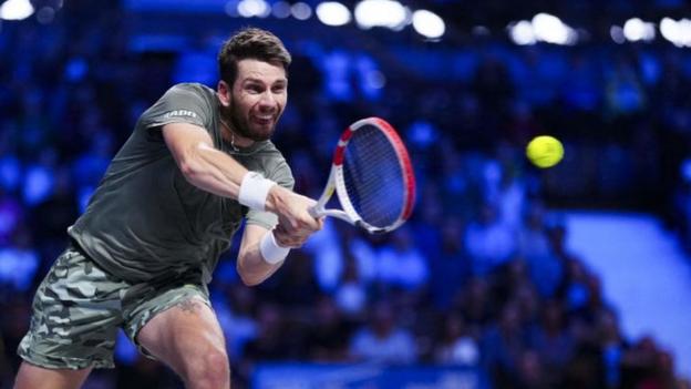 Cameron Norrie hits a return at the Paris Masters