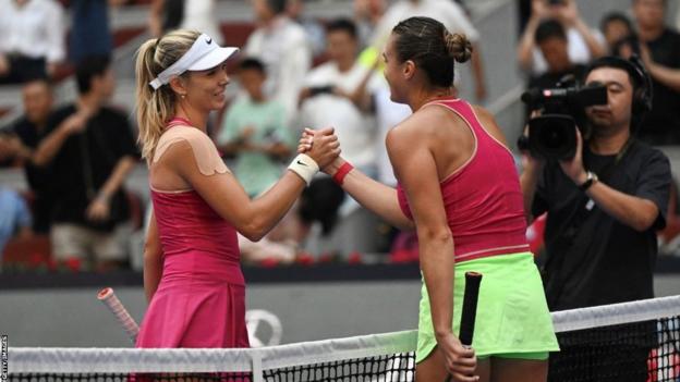 Katie Boulter and Aryna Sabalenka shake hands at the end of their match at the China Open