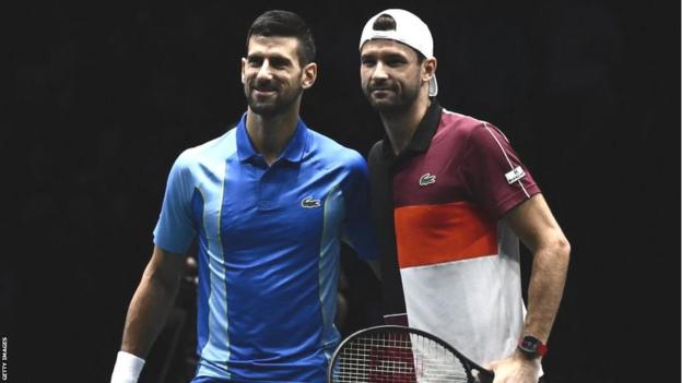 Novak Djokovic and Grigor Dimitrov pose for a photo together at the net