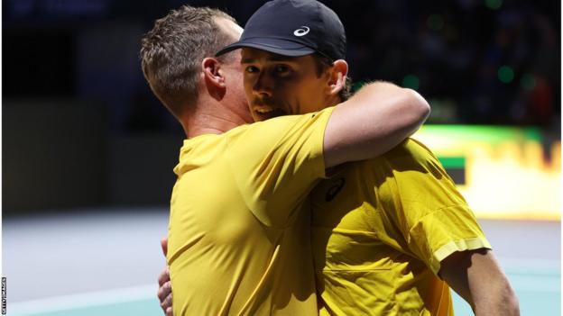 Australia captain Lleyton Hewitt hugging Alex de Minaur after his win over Emil Ruusuvuori