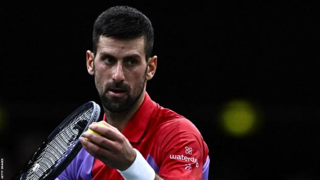 Novak Djokovic serves against Tomas Martin Etcheverry at the Paris Masters